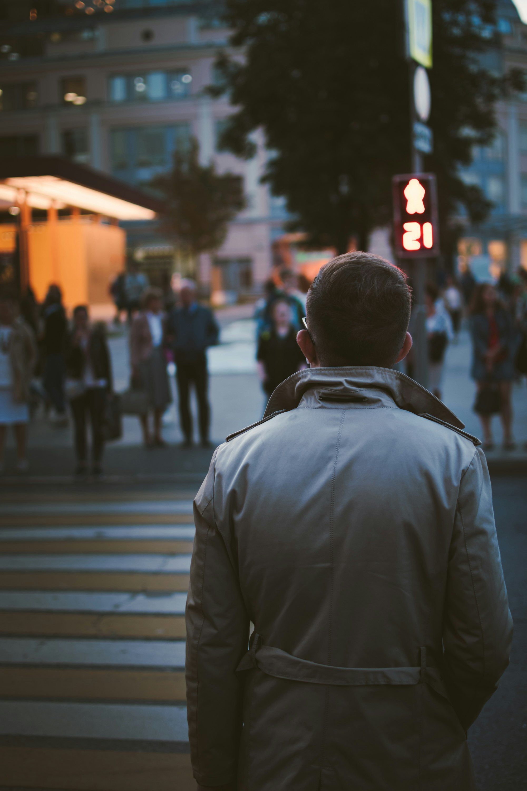 selective-focus photography of man walking on street